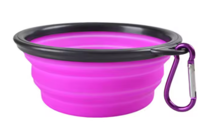 Purple silicone dog bowl with black rim and purple carabiner on a white background
